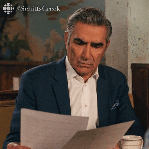 GIF of a man looking up from a piece of paper while asking "What am I looking at?"