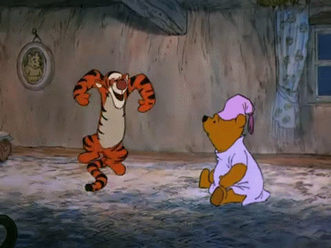 GIF of Tigger bouncing in a circle while Winnie the Pooh watches him.